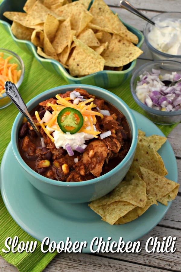 Bowl of Slow Cooker Chicken Chili topped with sour cream and cheese.