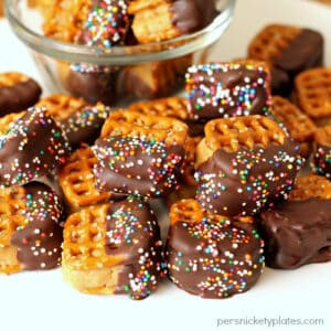 Close up image of a pile of peanut butter cream cheese pretzel bites on a white plate.