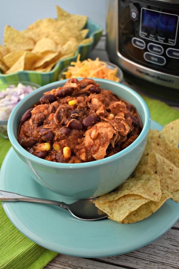 Slow Cooker Chicken Chili in a blue bowl with tortilla chips.