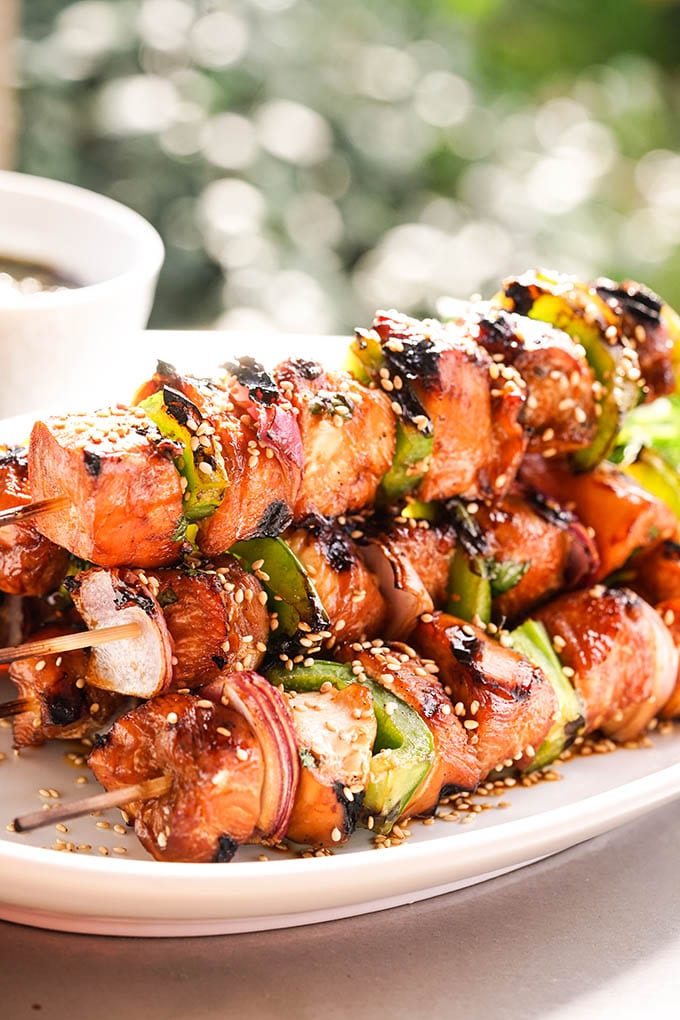A white platter filled with grilled Teriyaki Chicken Skewers.