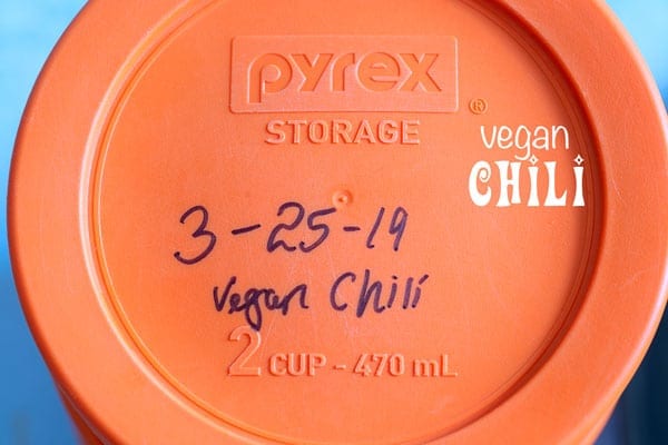 Overhead view of a Pyrex lid with the date and name of recipe written on it