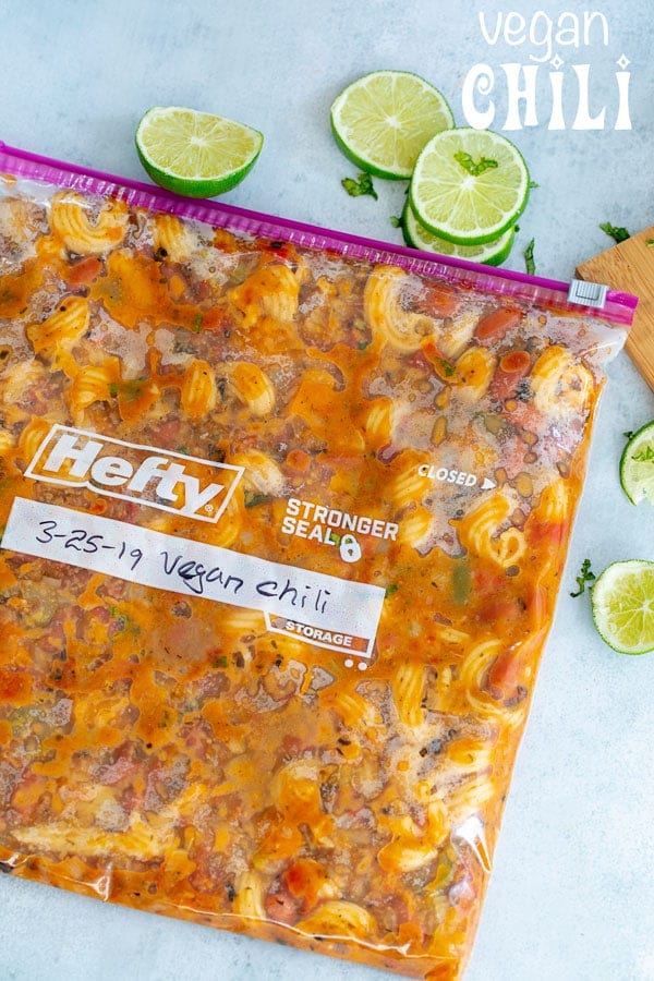 Overhead view of vegan chili in a ziplock bag ready to be frozen