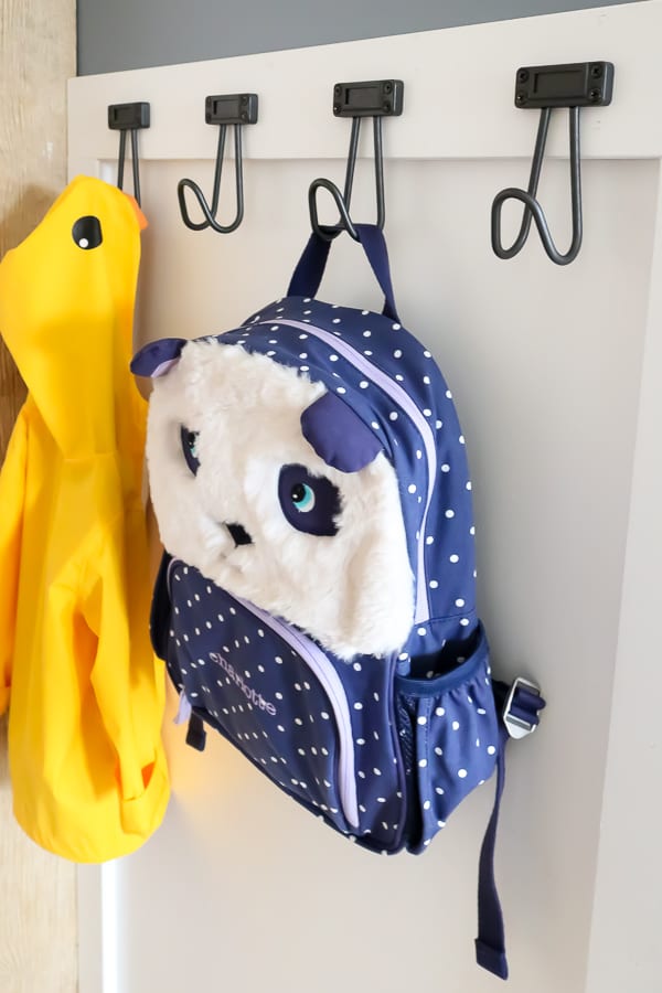 An organized entryway, with hooks for backpacks and coats.
