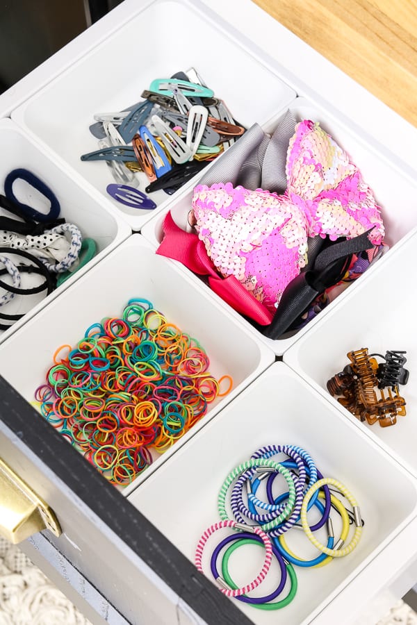 Organized hair accessories in a drawer.