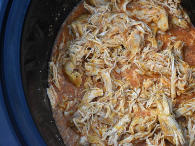 Shredded Slow Cooker Buffalo Chicken in a crock pot.