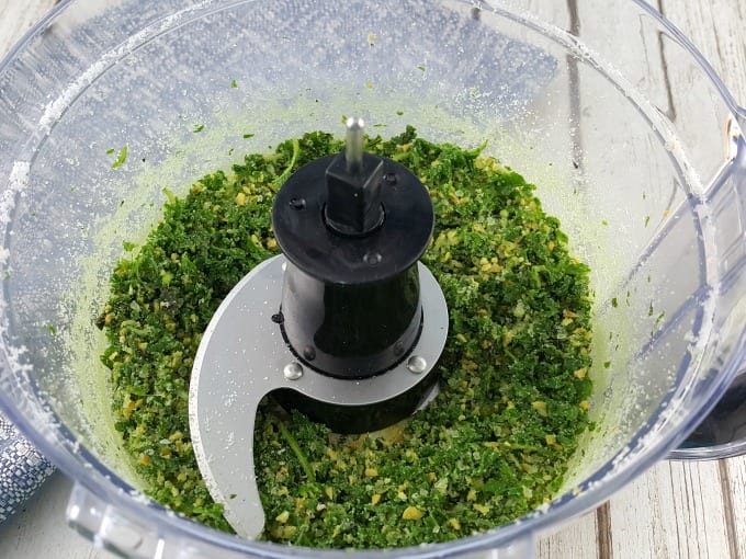 Ground fresh basil, dried minced garlic and kosher salt in a food processor.