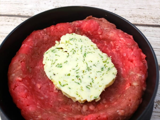 making butter burgers: ground beef in a burger press mold with cowboy butter in the middle.
