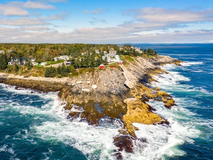 A view of Pemaquid Point Lighthouse on Muscongus Bay and Johns Bay in Bristol Maine as seen from the air.