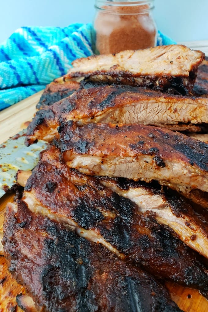 A pile of St. Louis Style Ribs on a cutting board.