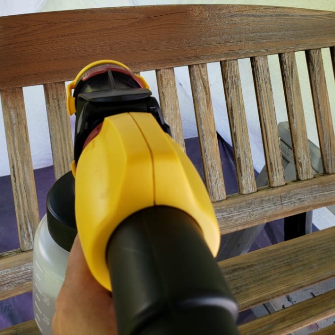 A wooden swing bench being painted using the Wagner Flexio 4000 paint sprayer.