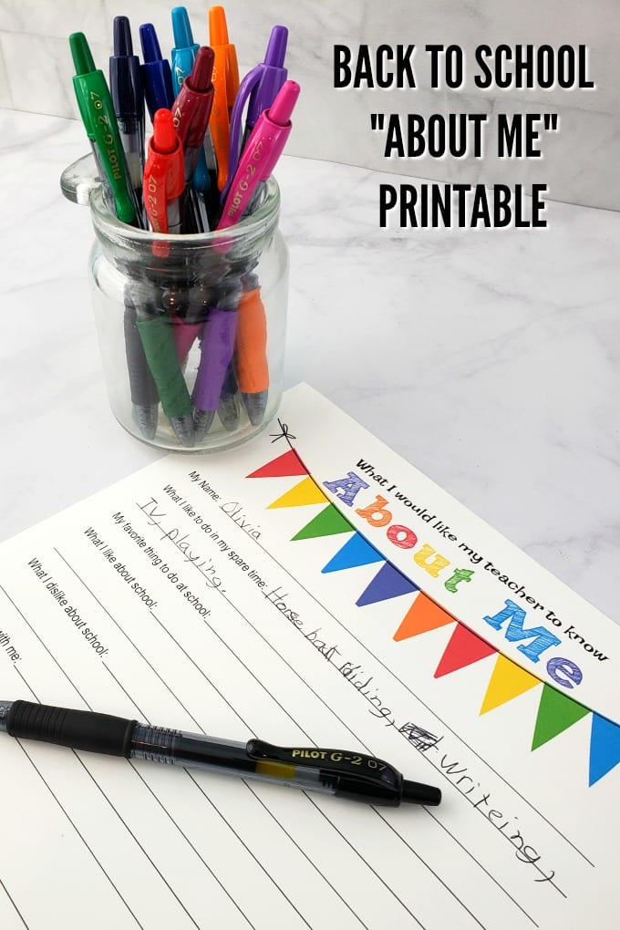 pens in a small clear jar on a marble counter with a free printable and pen