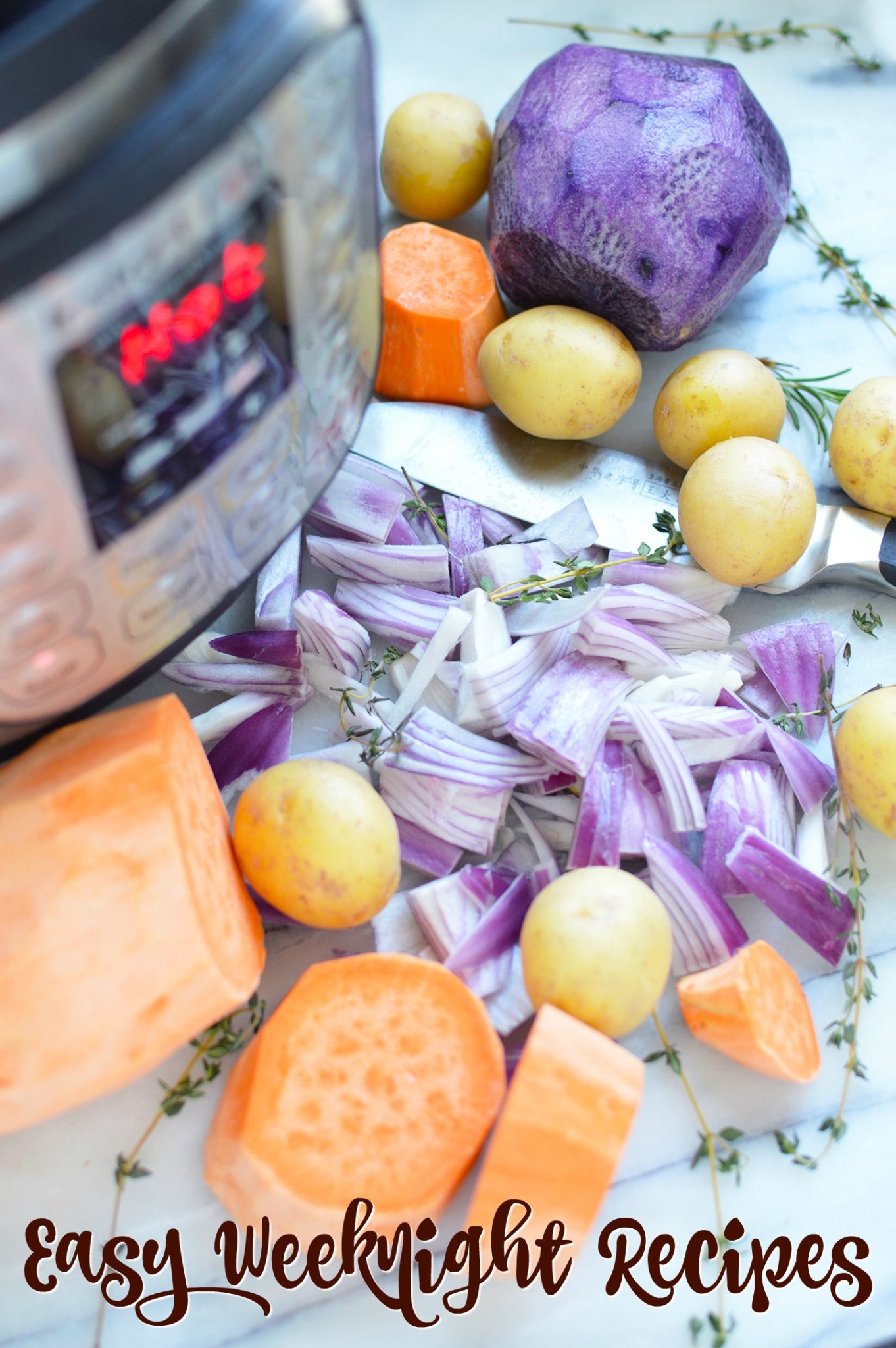 45+ Easy Weeknight Recipes - close up of onions, potatoes and sweet potatoes on a counter top next to an Instant Pot and a knife.