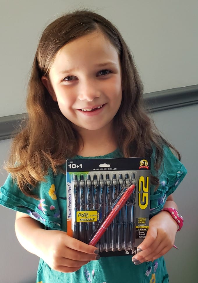 Classroom Supplies for Teachers: a girl holding a package of pens