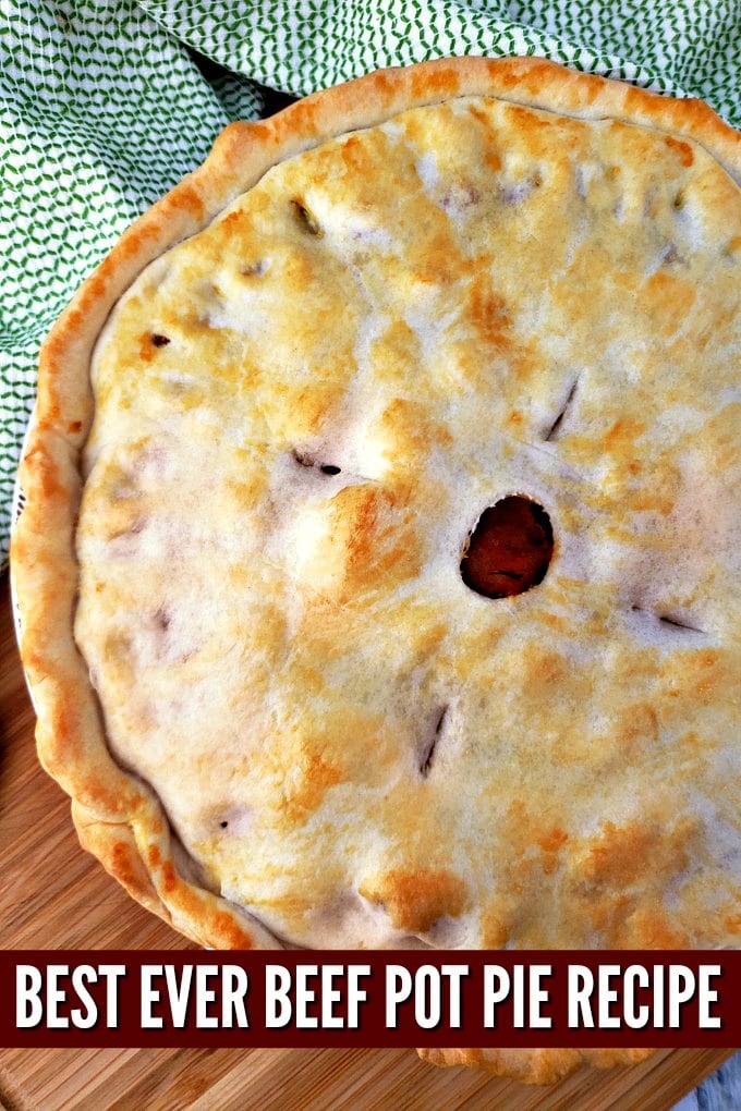 A pie with golden brown crust rests on a cutting board.