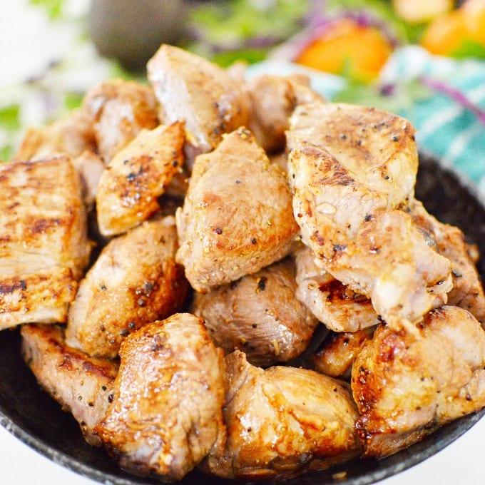 close up of cooked cubed pork shoulder in a bowl