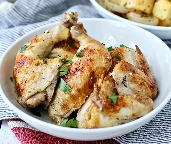 Sheet pan chicken cut up in a serving bowl. 