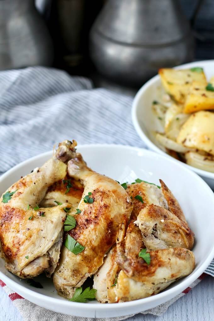 Sheet pan chicken with roasted potatoes in bowls.