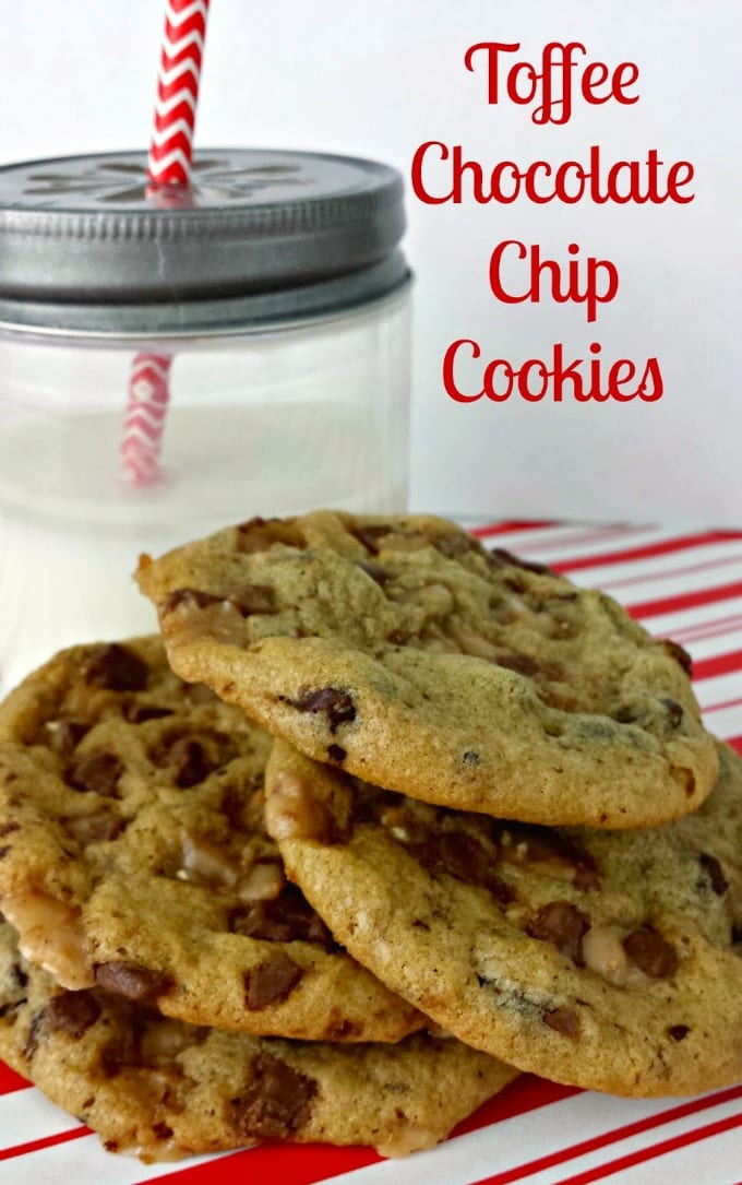 Vertical image of chocolate chip toffee cookies stacked in front of a glass of milk.