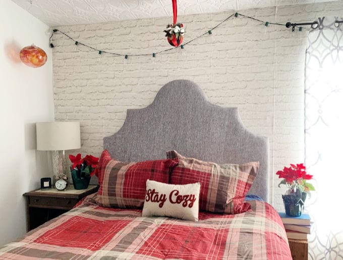 Bedroom decorated for Christmas with kissing ball hanging from ceiling.