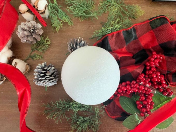 Top down image of inexpensive supplies to make a kissing ball.
