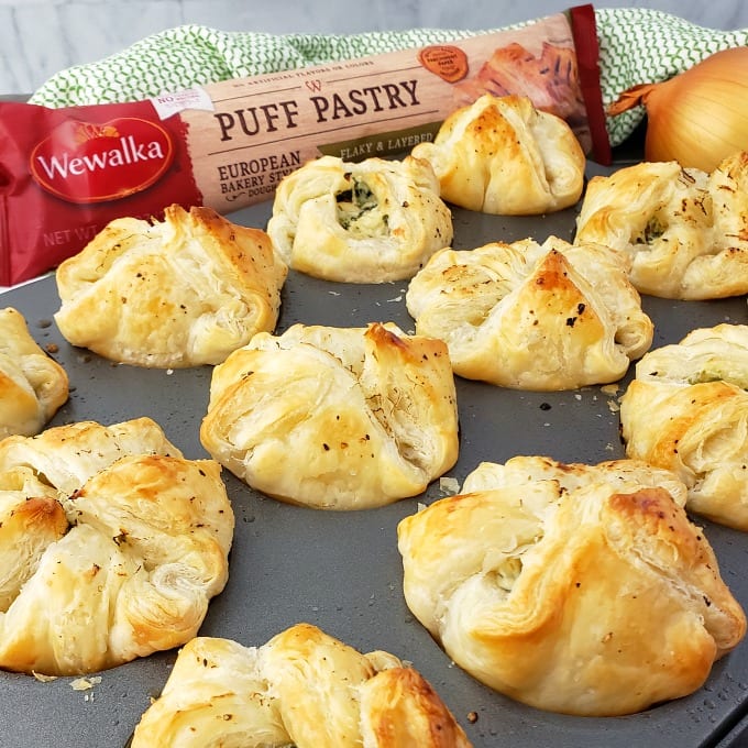 Baked Spinach Puff Pastry appetizers in a muffin pan next to Wewalka Puff Pastry dough.