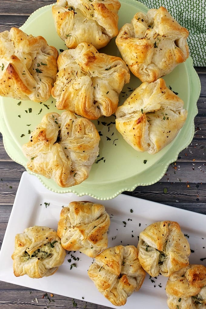 Golden brown Spinach Puff Pastry appetizers on a serving platters.