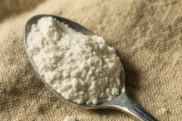 Close up of a spoonful of cream of tartar.