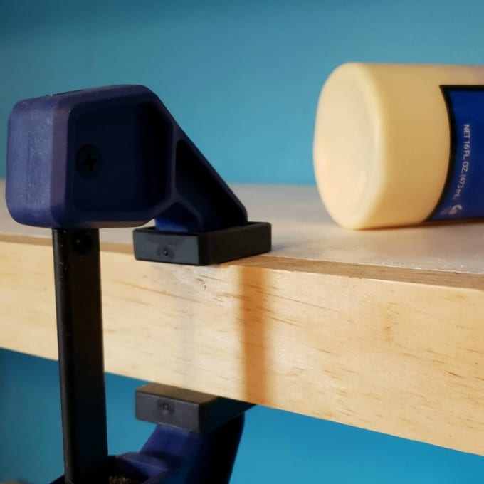 clamps hold a a floating shelf together while glue dries for floating shelves