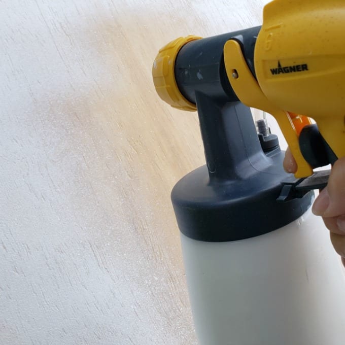 a Wagner SprayTech 4000 paint sprayer to paint plywood white.