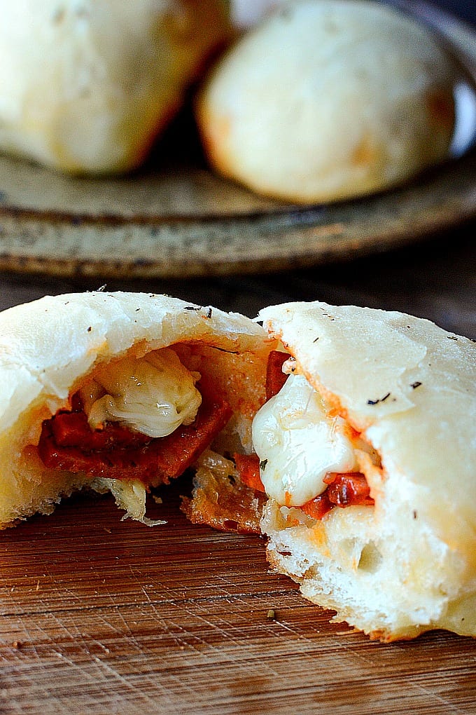Close up of a stuffed pizza roll cut in two.
