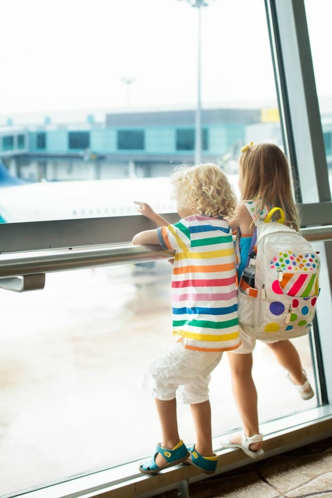 Two children in an airport terminal - Tips for Flying with Kids