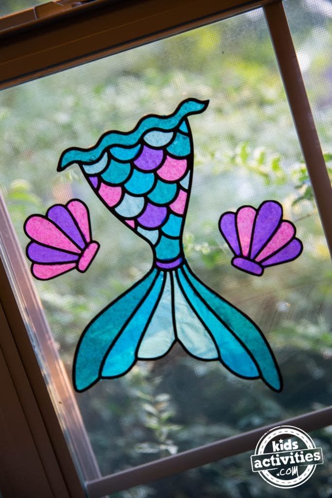 Mermaid Tail Suncatcher hanging in a window.