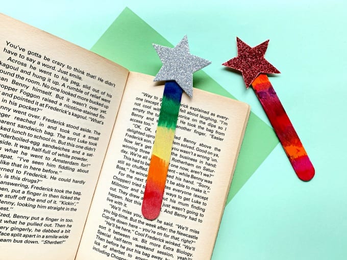 Painted Craft Stick Star Bookmarks shown on a book.