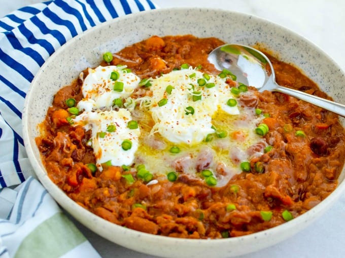 close up of Instant Pot Beef Chili topped with sour cream and garnished with chives.