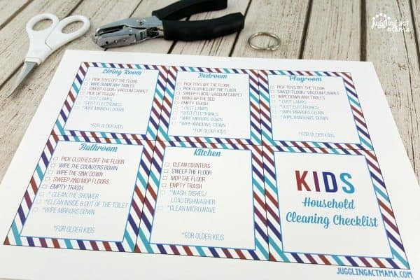 Printout of kids household cleaning checklist, a hole punch, and scissors.