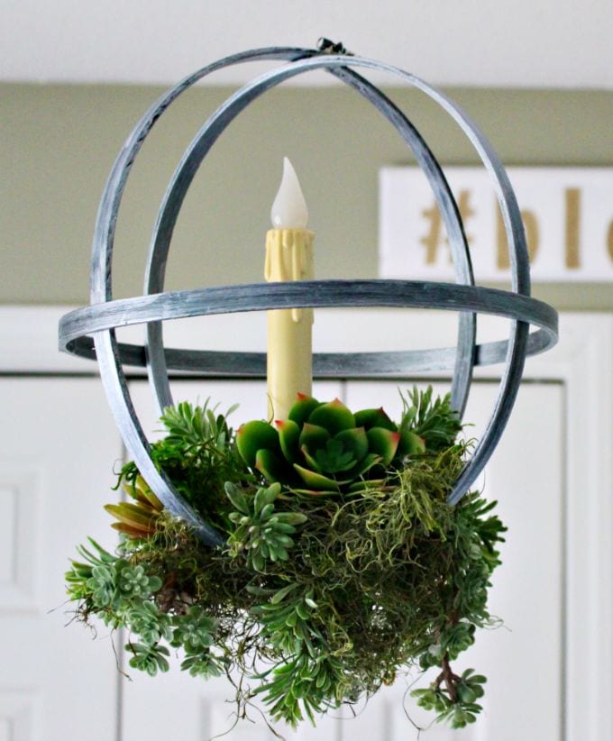 a succulent planter with faux succulents built with embroidery hoops and hung like a chandelier