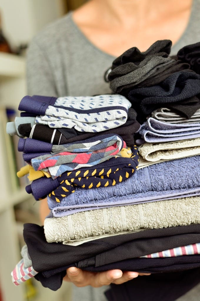 Declutter Challenge - woman holding clothes to donate.