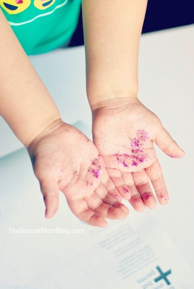 Child's hands covered in glitter.