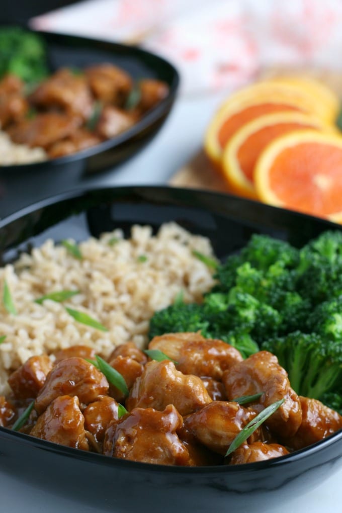 Close up of a bowl filled with rice, broccoli and instant pot orange chicken.