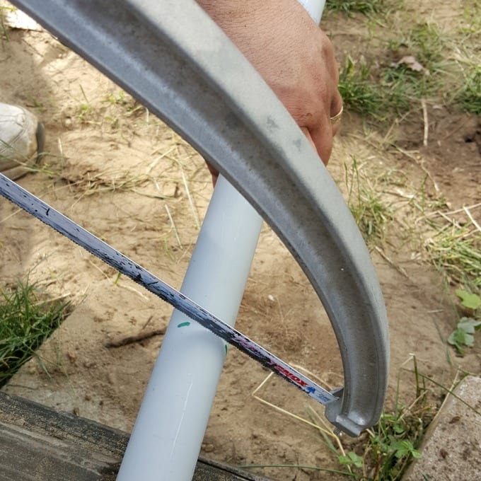 Saw cuting through pvc pipe.