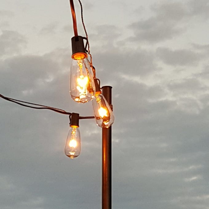 how to hang patio lights - string lights on a guidewire