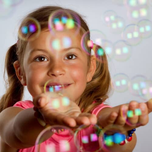 Girl playing with Homemade Bubbles.