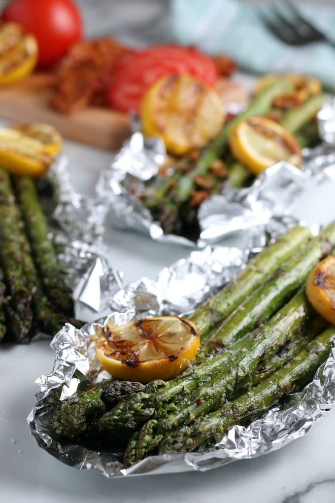 How to Grill Asparagus in Foil - close up of asparagus with grilled lemons