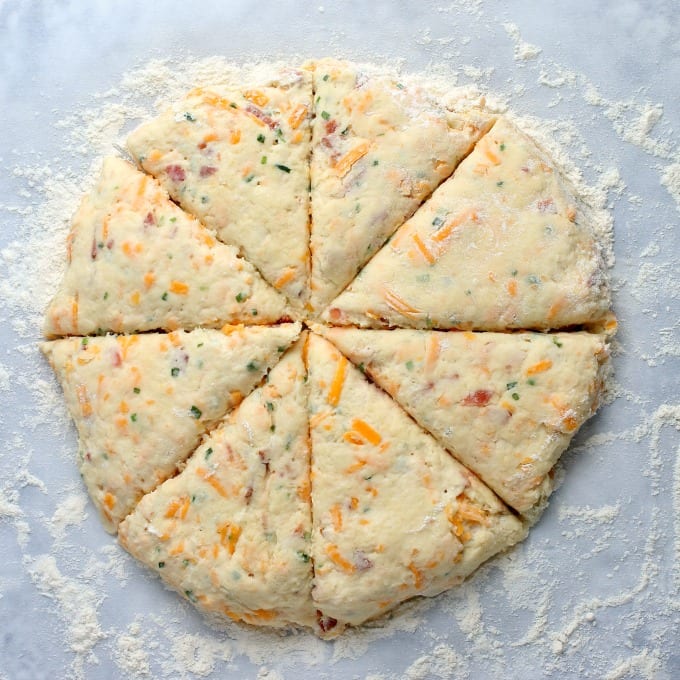 Top down image of scone dough on a flour dusted countertop.