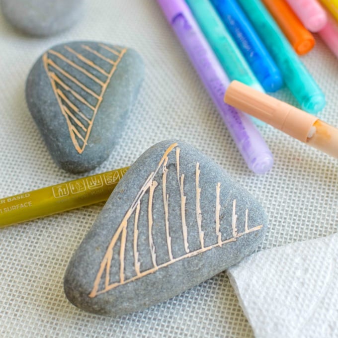 Gray rocks with peach ice cream cones painted on them,