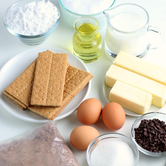 The basic ingredients for S'mores Cupcakes - graham crackers, eggs, chocolate cake mix, butter, chocolate chips, oil, milk, and sugar.
