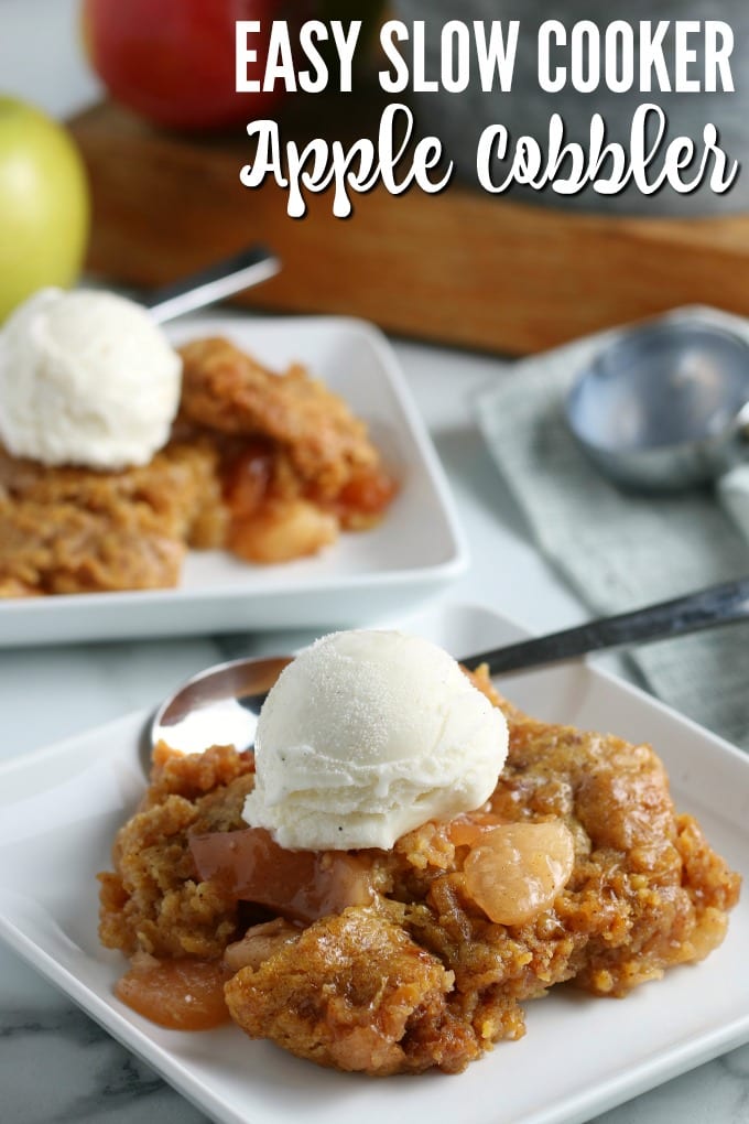 Slow cooker apple cobbler on a square white plate, topped with vanilla ice cream. 