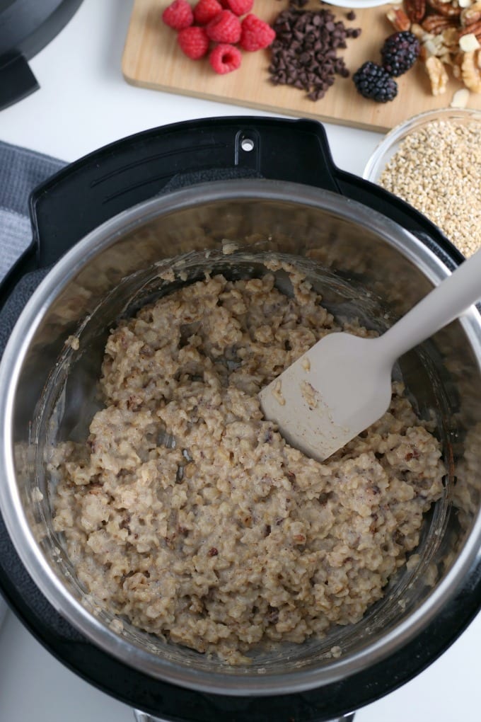 Top down view of an instant pot full of oatmeal with spatula.