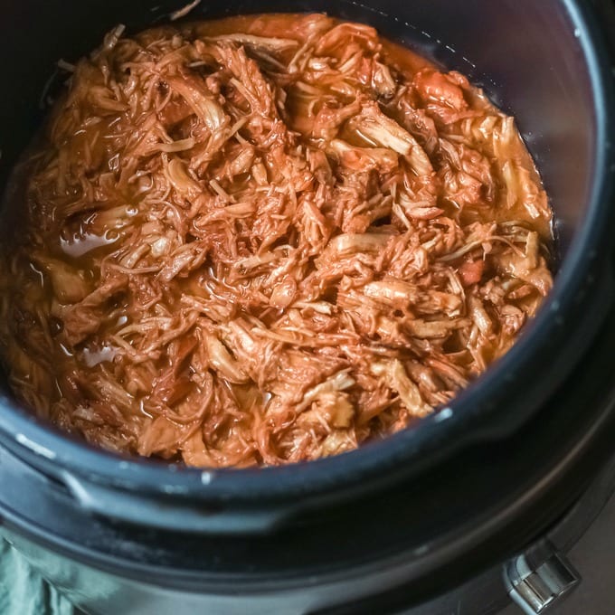 Top down view of bbq chicken in a crock pot.