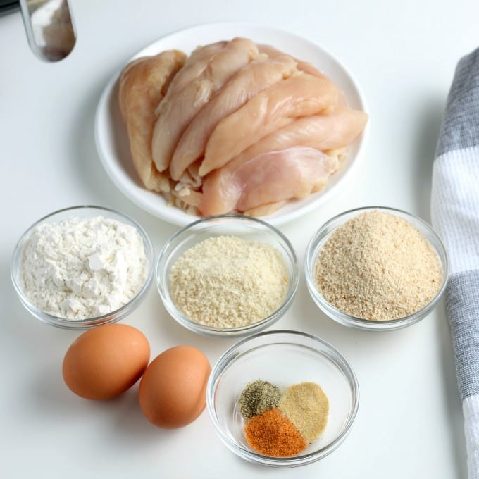 Ingredients for air fried chicken tenders - chicken, flour, breadcrumbs, eggs and seasonings.